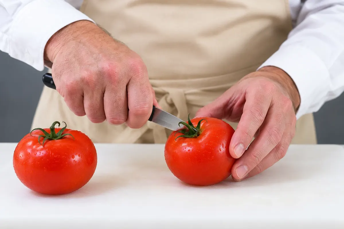 Preparation of the raw tomatoes for the salade niçoise.